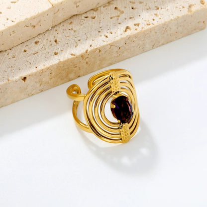 Striking Contrast Between Rough Textured Gold and Smooth Faceted Gemstone