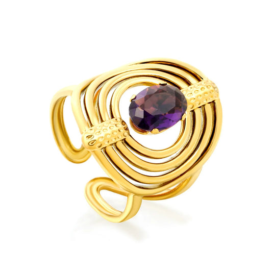 Striking Contrast Between Rough Textured Gold and Smooth Faceted Gemstone