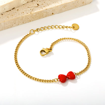 Express Vibrant Passion with Bold Red Enamel Double Hearts Tied in a Bow