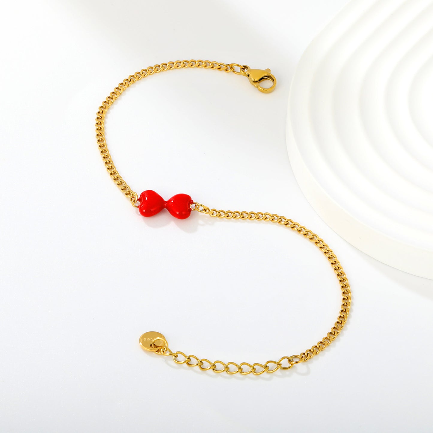 Express Vibrant Passion with Bold Red Enamel Double Hearts Tied in a Bow
