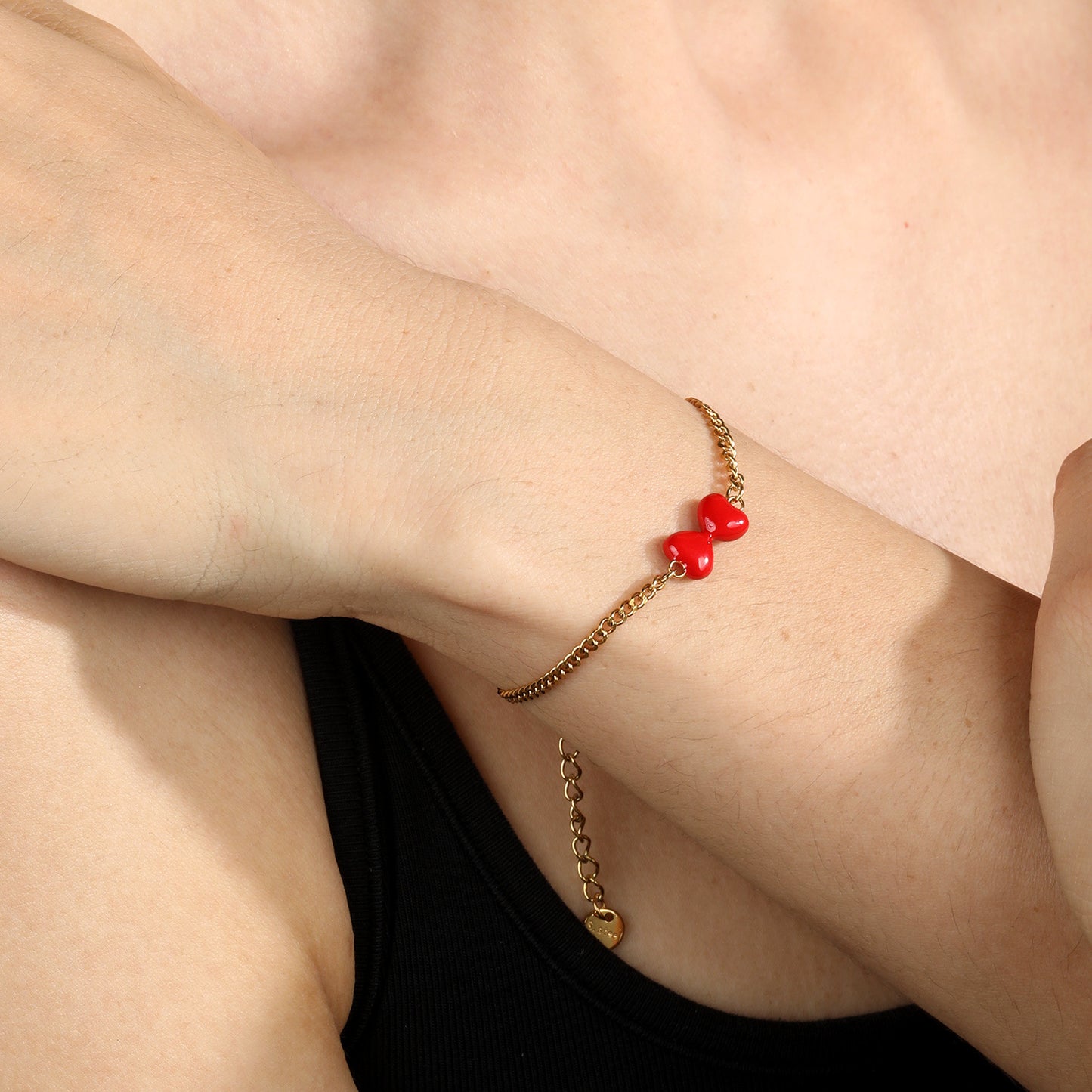 Express Vibrant Passion with Bold Red Enamel Double Hearts Tied in a Bow