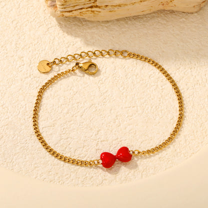 Express Vibrant Passion with Bold Red Enamel Double Hearts Tied in a Bow